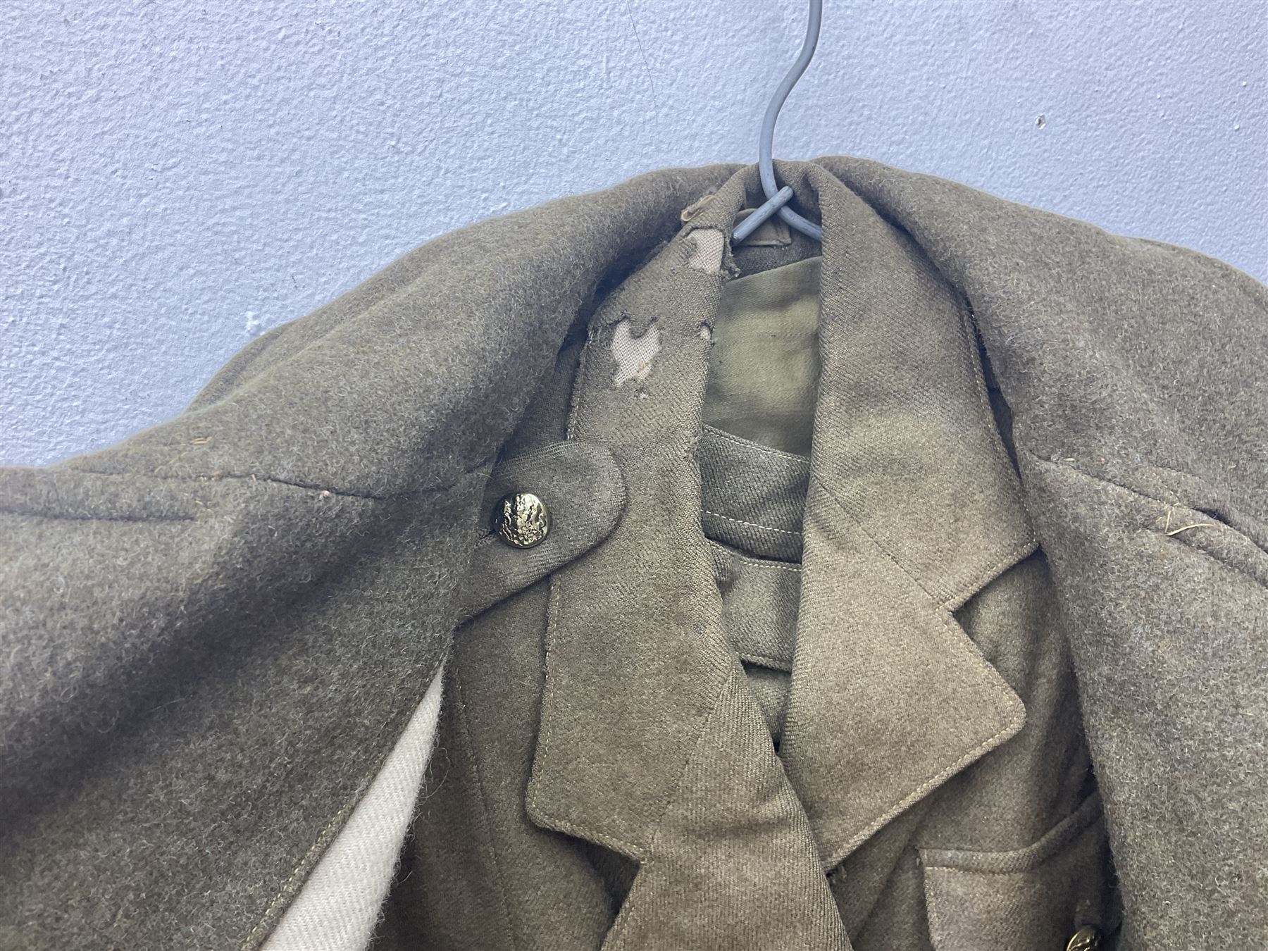 WW2 British female ATS Sergeant's service uniform grouping, consisting of four pocket female pattern service dress tunic with brass ATS shoulder titles and general service buttons; cloth lined interior with the original printed size label dated 1942; the matching khaki service dress skirt; and Greatcoat with size label dated 1945; together with army knitted sleeveless V-neck jumper; WRAC tunic, skirt and overcoat; full length cream and gold thread military evening dress by Hilliers Couture; and four webbing belts