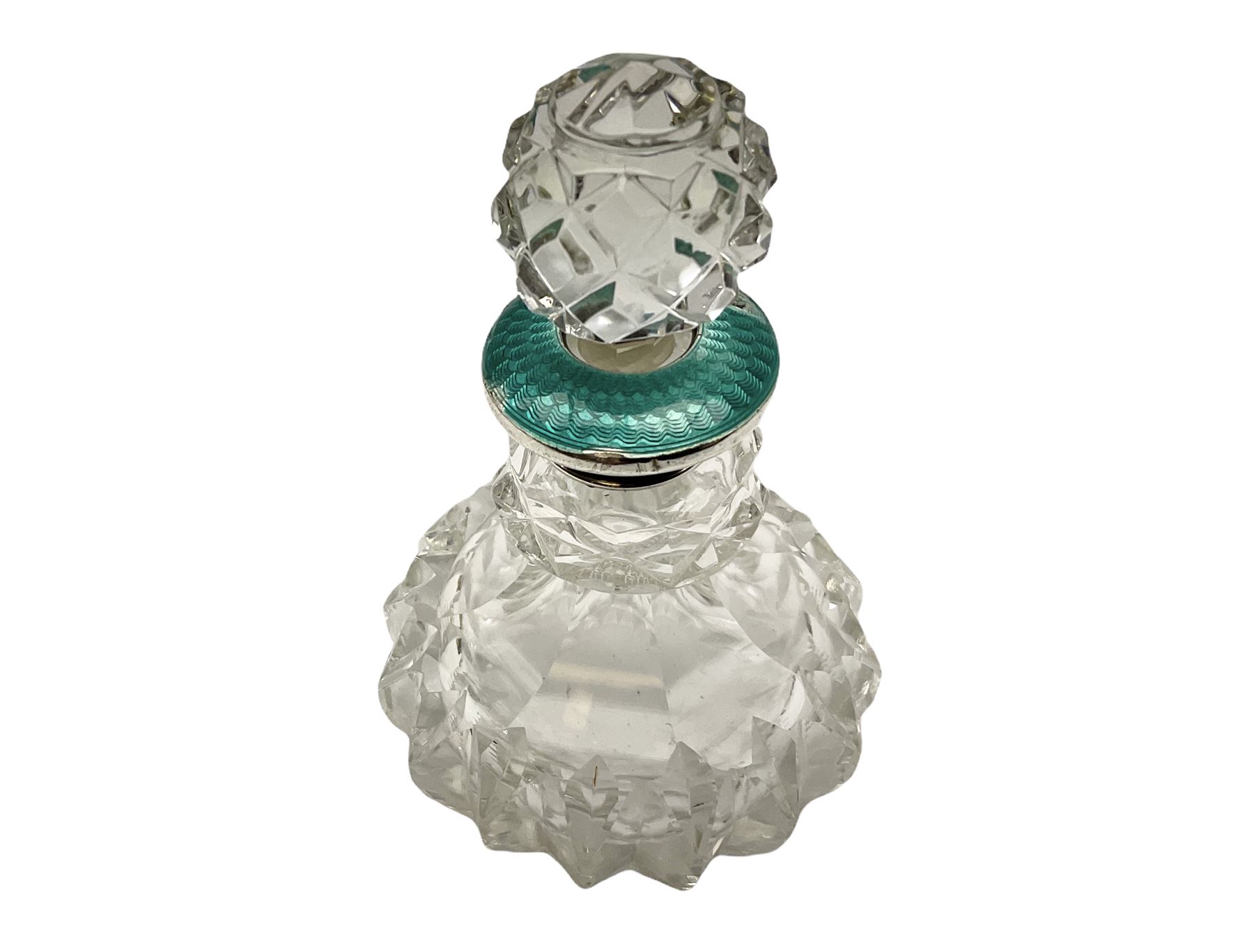 Cut glass perfume bottle of bellied form, the silver mounted cover with turquoise guilloche enamel top, hallmarked Henry Perkins & Sons, London 1927, together with a cut glass perfume bottle with silver mounted and yellow guilloche enamel lid, hallmarked Albert Carter, Birmingham 1950, Continental silver perfume bottle, of barrel form with embossed figural detail, stamped 930, scent bottle of bellied form with white metal foliate pierced overlay, amethyst glass scent bottle of flask form with foliate embossed white metal cover and suspension ring and chain, and three further examples, including one of ovoid form with painted decoration and silver cover, hallmarked for Birmingham.