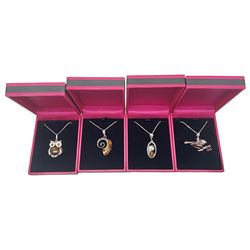 Four silver amber pendant necklaces, comprising shell, bird on a branch, owl and cheetah, stamped 925, all boxed