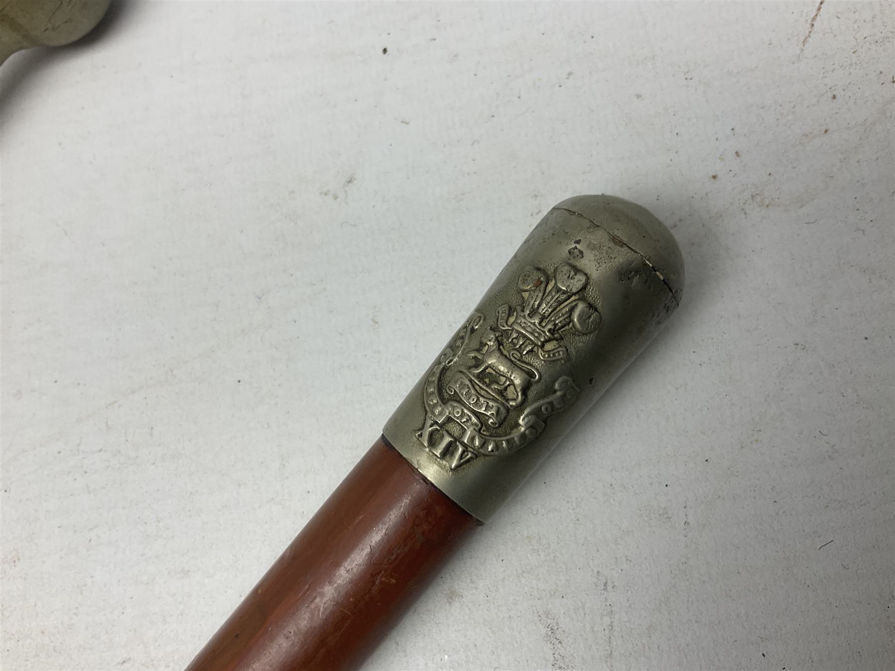 George V 1897 pattern Army Officer's sword by Henry Wilkinson Pall Mall London, the 82.5cm 'London Made' blade etched to both sides with Royal Crests and cyphers etc, pierced half-basket hilt with wire-bound fish skin grip and remains of leather knot strap; in leather covered field service scabbard L101cm overall; and two 14th Prince of Wales Own swagger sticks (3)