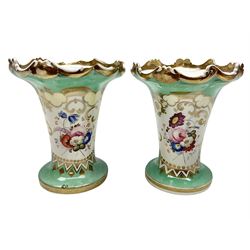 Pair of 19th century vases, of tapering cylindrical form, decorated with hand painted floral spray within a gilt bordered panel, against a green ground, H14cm