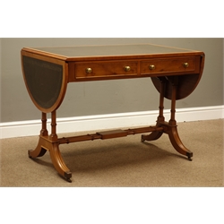  Quality reproduction yew wood Recency style sofa table, curved drop leaf with inset green leather, two drawers, on splayed supports with brass cups and castors, collar turned stretchers, W102cm, H73cm, D61cm (closed)   