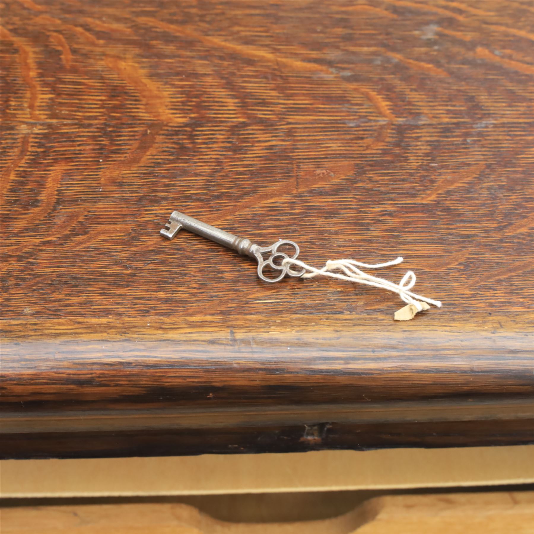 Early 20th century oak tambour front fitted cabinet, rectangular top with rounded corners over a roll tambour front enclosing a fitted interior of multiple shallow drawers with cut-out pulls, the sides with rounded uprights, on a stepped plinth base
