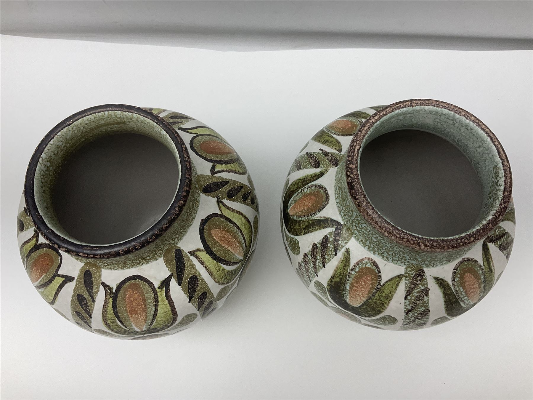 Pair of Denby Glyn Colledge stoneware vases of baluster form with floral decoration over cream ground, together two jardiniere in a similar design, vases H24cm