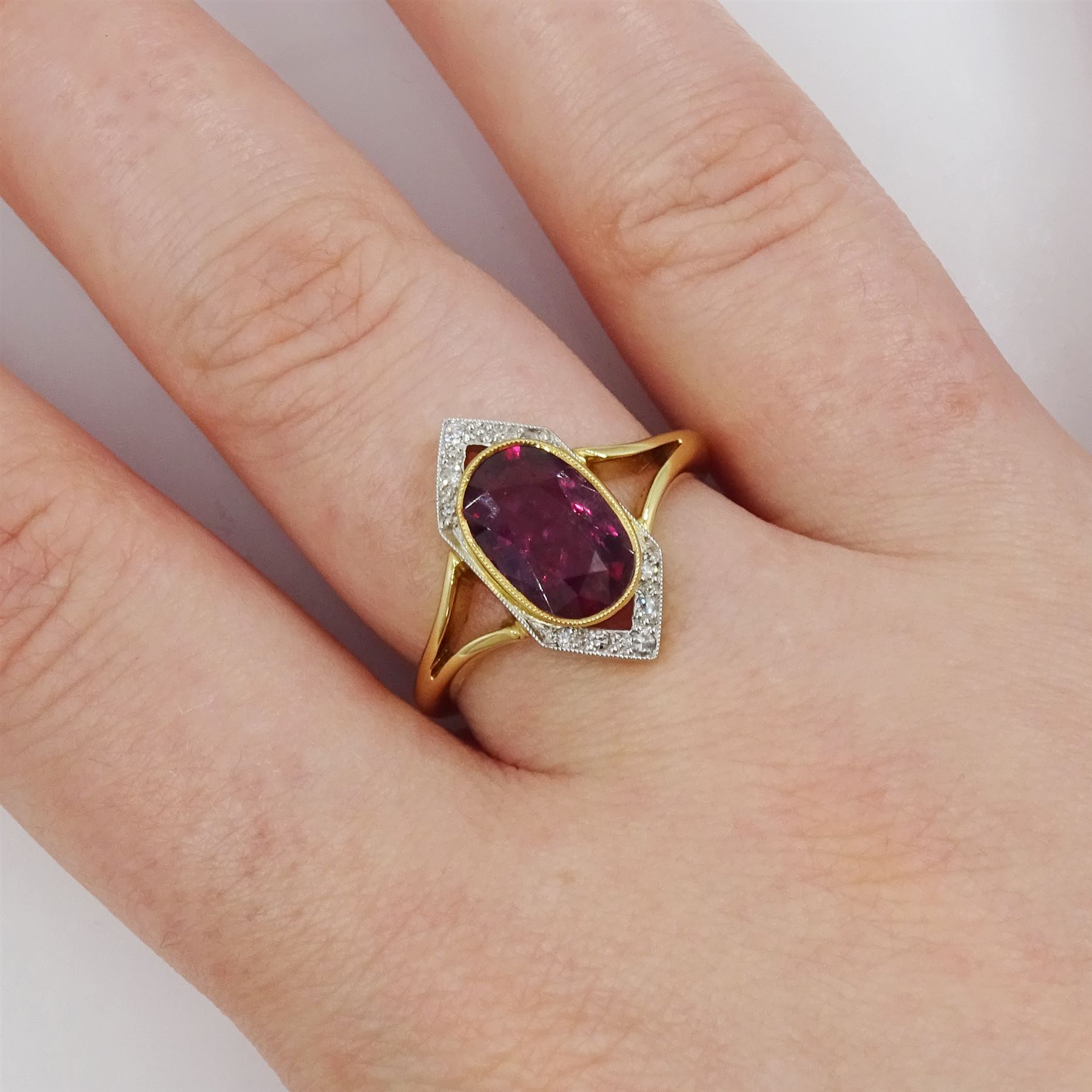 18ct and platinum ruby and diamond ring, single oval cut ruby of approx 2.26 carat, with old cut diamond surround, set within a milgrain navette shaped border, London 2019, total diamond weight approx 0.15 carat, with Alan Poultney Gems report