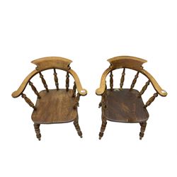 Pair of captains smokers bow chairs, spindle tub shaped back and saddle seat, raised on turned supports united by double H stretcher