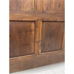 Late 19th century French walnut double bedstead, the panelled headboard with curling foliage carved frieze over concentric turned roundels and faceted mounts, lion mask carved rails with applied panelled mounts, matching footboard with lower carved lion mask 