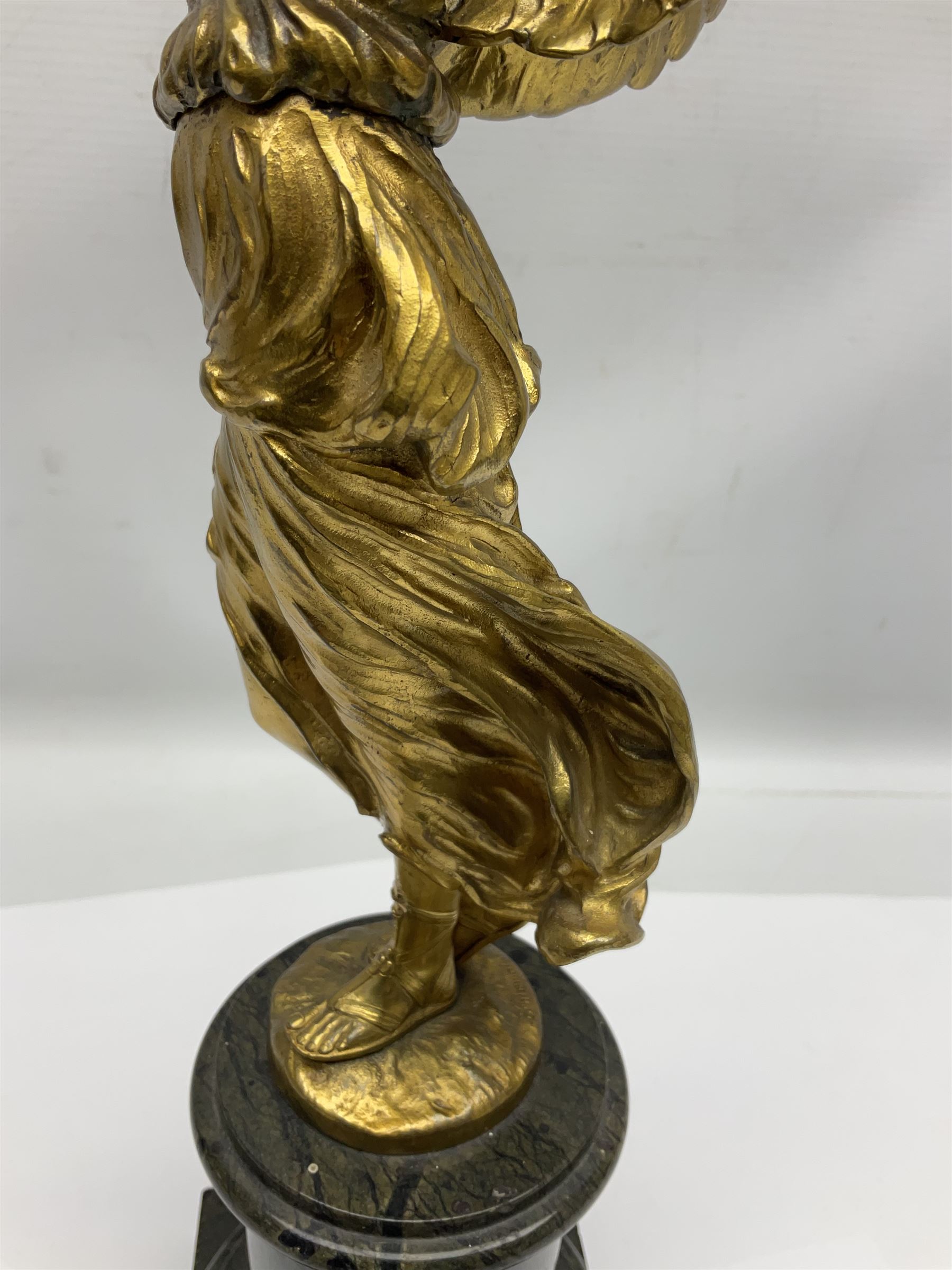 After Oswald Schimmelpfennig (German, 1872-1939): Pair of gilt bronze winged Allegorical female figures, the first example with arm outstretched holding a branch, signed 'Schimmelpfennig 1900', the second with arm raised above her head holding a book and sword in the other, both raised upon marble plinths, H45cm
