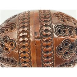 Three 19th century coquilla nut pomanders or flea catchers, two of egg shaped form and the third of barrel from with carved and pierced decoration and screw threaded join, largest H8cm