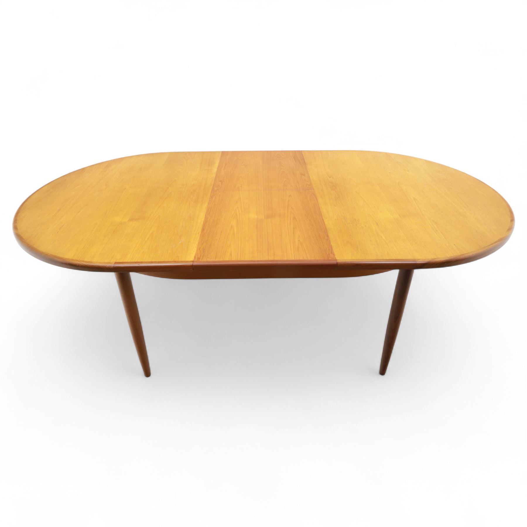G Plan - mid-20th century teak extending dining table, oval top with integrated extension leaf, raised on tapering legs, together with a set of six slat back dining chairs including two carvers, upholstered in dark green velour (Extends to 210cm)
