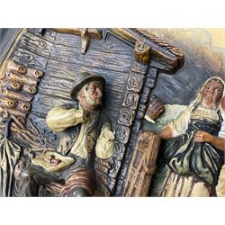 Two oil painted chargers decorated with joyful gentleman, both signed W Stanley, together with a Musterschutz charger decorated in high relief