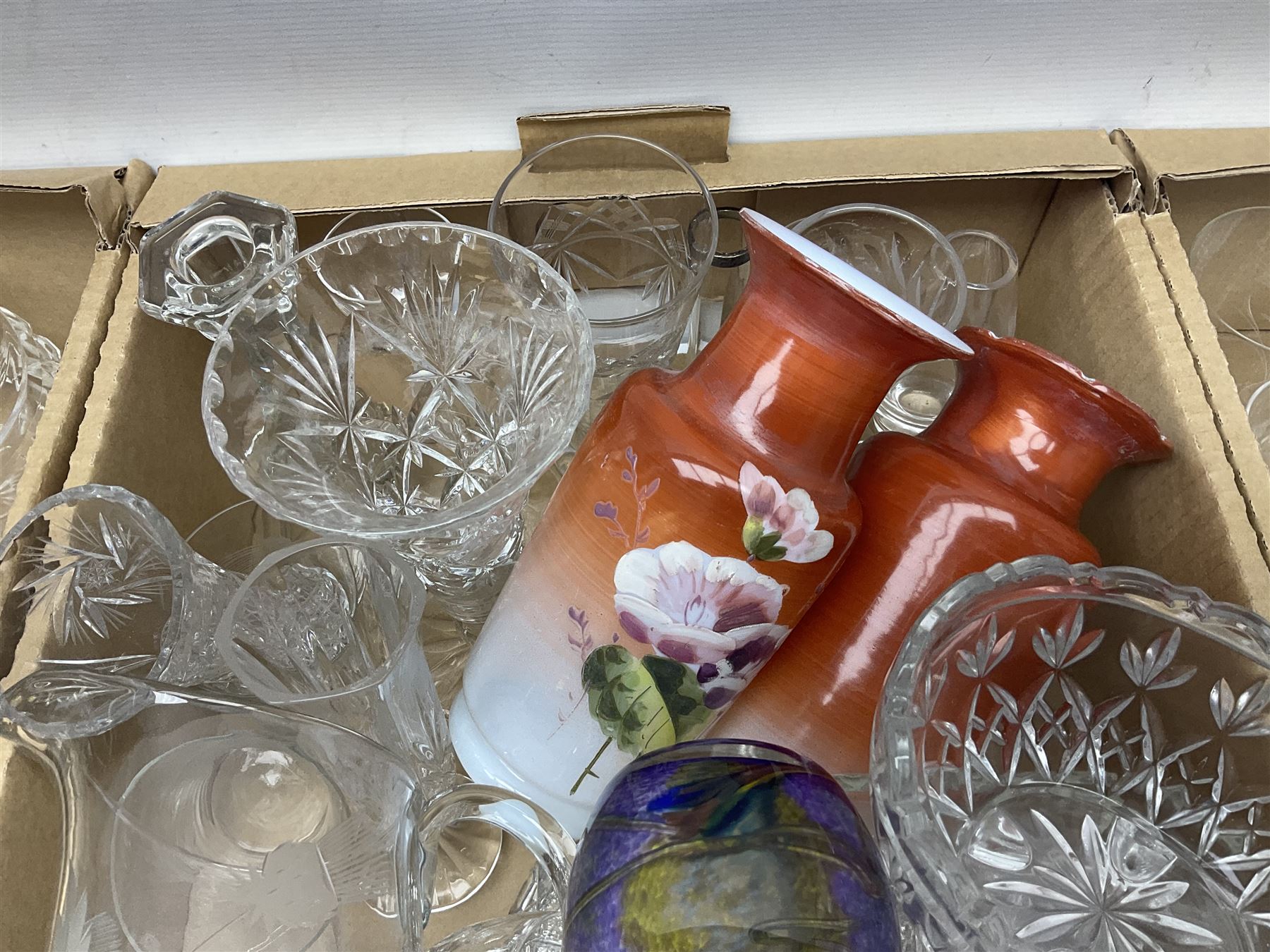 Four boxes of glassware to include painted vases, jugs, drinking glasses, art glass vase etc