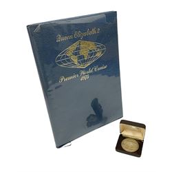 Queen Elizabeth II silver medallion, hallmarked Birmingham 1974, cased and with the 'Premier World Cruise 1975' hardback book
