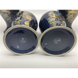 Two pairs of Royal Winton vases, decorated with peacocks on a blue ground, largest H24cm