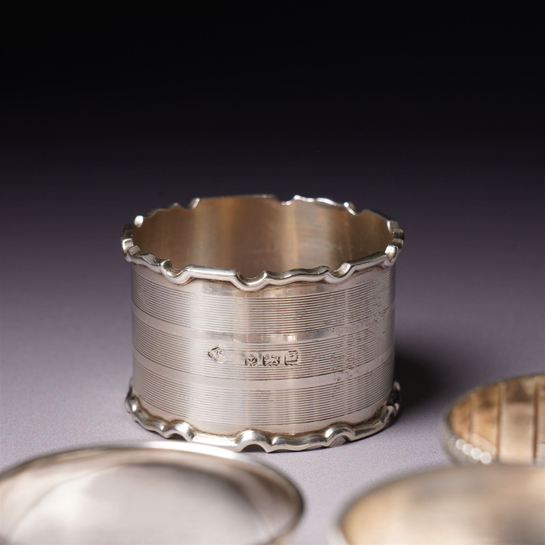 Three engraved silver napkin rings and four others (7)