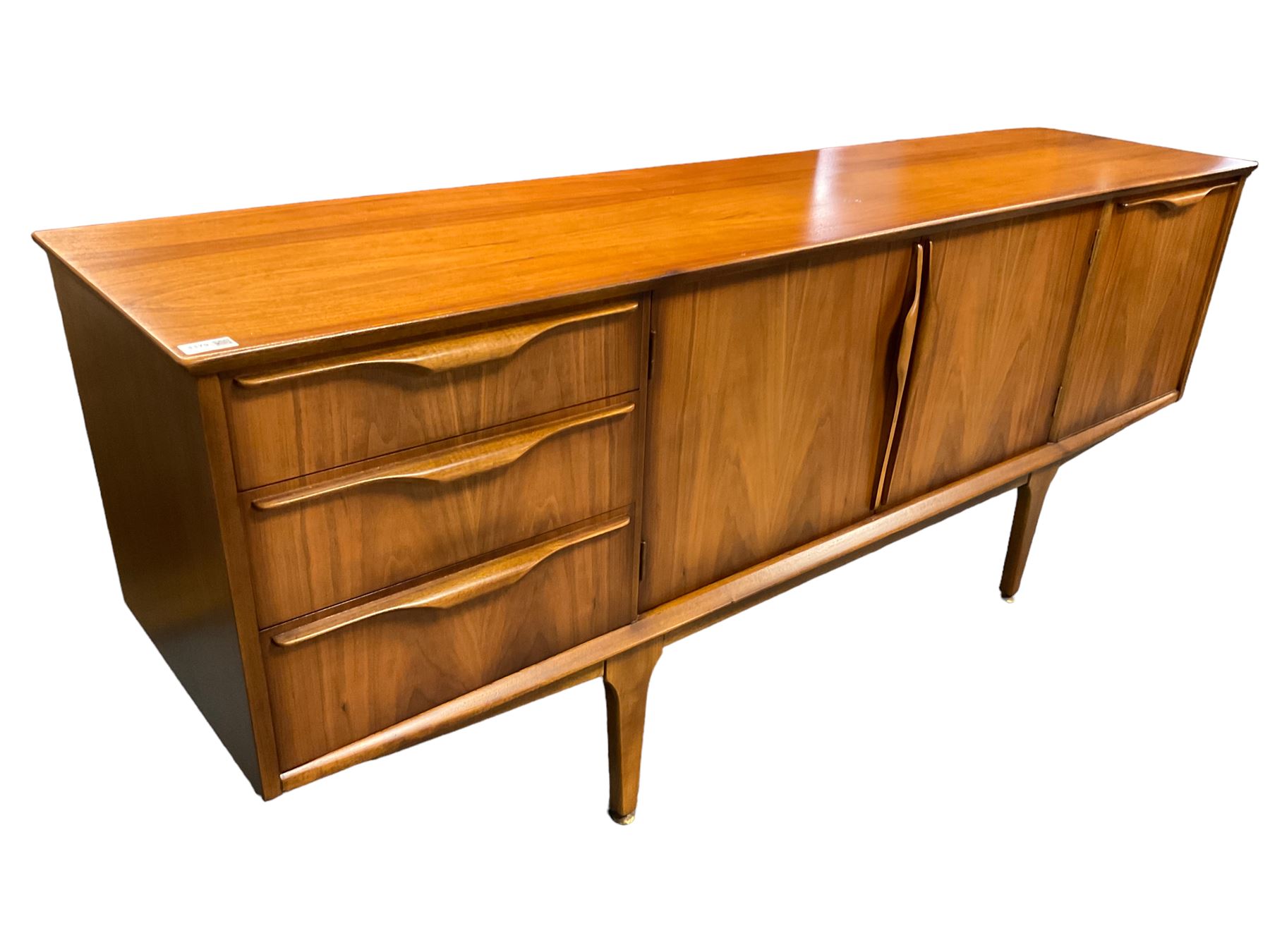 Jentique - mid-20th century teak sideboard, fitted with three drawers, double cupboard and fall front cupboard, raised on tapering supports