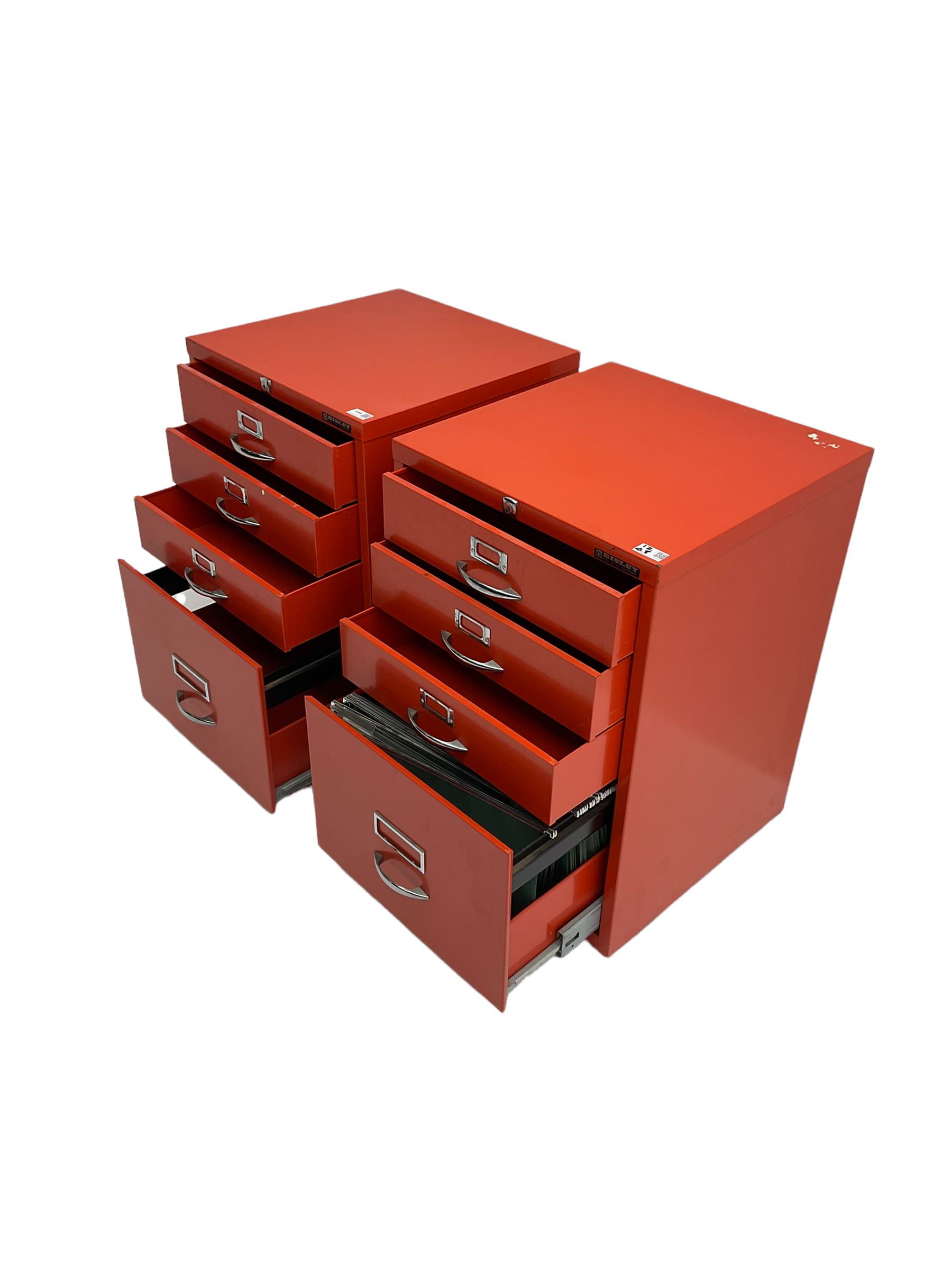 Two red finish 'Bisley' four drawer filing cabinet
