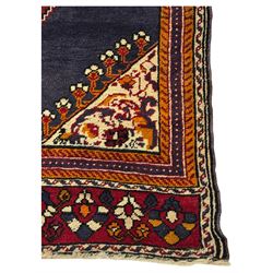 West Persian Hamadan rug, hand knotted, central medallion bordered by geometric and intricate floral motifs, displaying red cream and indigo colours with an orange coloured border  