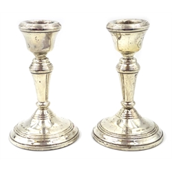  Pair of silver miniature candlesticks Birmingham 1979 11cm, an Edwardian cut glass trinket box with embossed silver top  