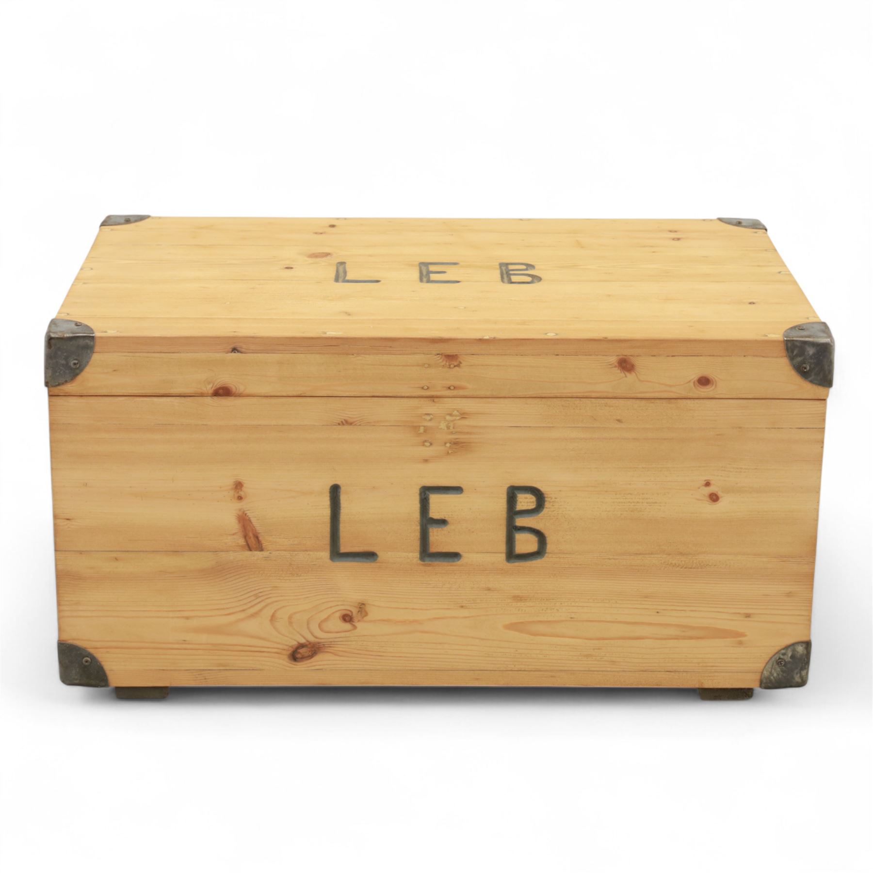 Pine storage trunk, of rectangular plank construction with metal corner protectors and stencilled lettering ‘LEB’ to front and lid
