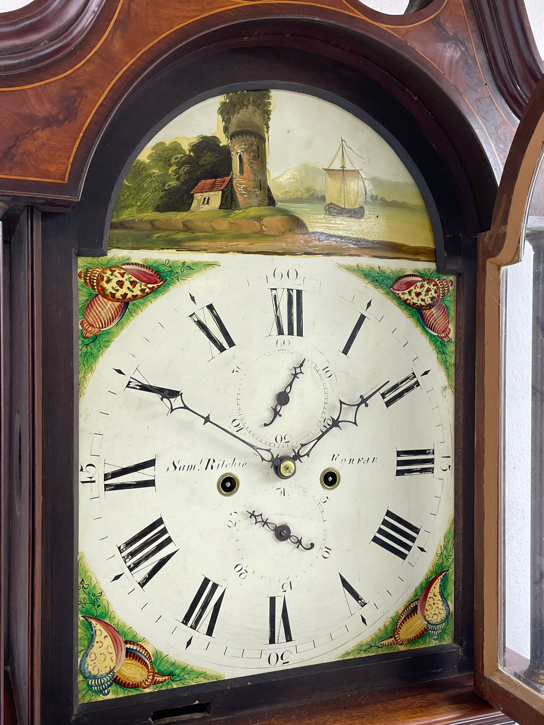 Samuel Ritchie of Forfar - William IV 8-day Scottish longcase clock in a mahogany case, with a swans neck pediment, brass paterae and three ball and spire brass finials, case and trunk inlaid with satinwood stringing on a plinth raised on decorative bracket feet, painted break arch dial depicting a costal scene to the break arch and conch seashells to the spandrels, Roman numerals, subsidiary seconds and date dials with matching steel hands, with a rack striking movement striking the hours on a bell. With weights, key, and pendulum.  Samuel Ritchie is recorded as working in Forfar 1800-37.