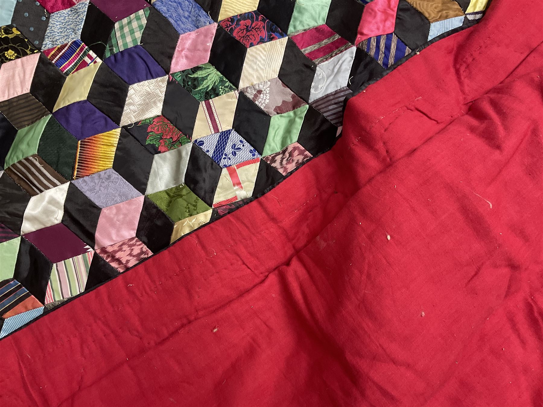 19th Century silk and satin tumbling blocks pattern patchwork quilt with black border 228cm X 196cm