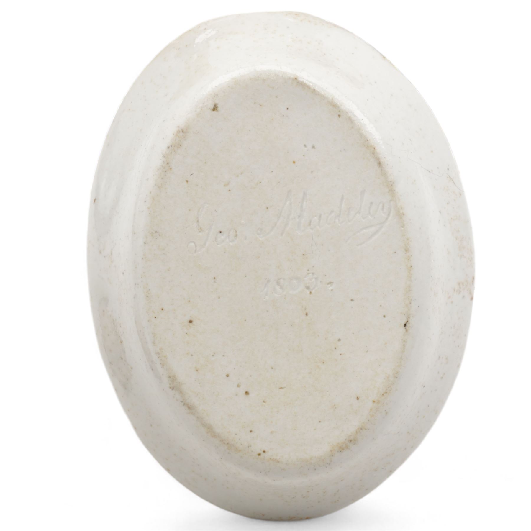 Early 19th century English porcelain miniature rosewater sprinkler in the form of a coffee pot, floral encrusted and painted body with flower knop handle and scroll handle, pattern no. 7916, H16.5cm, 19th century Rockingham style seated model of a Lion, L9.5cm and an early 19th century oval dish, inscribed beneath Geo. Maddey, 1803 (3)