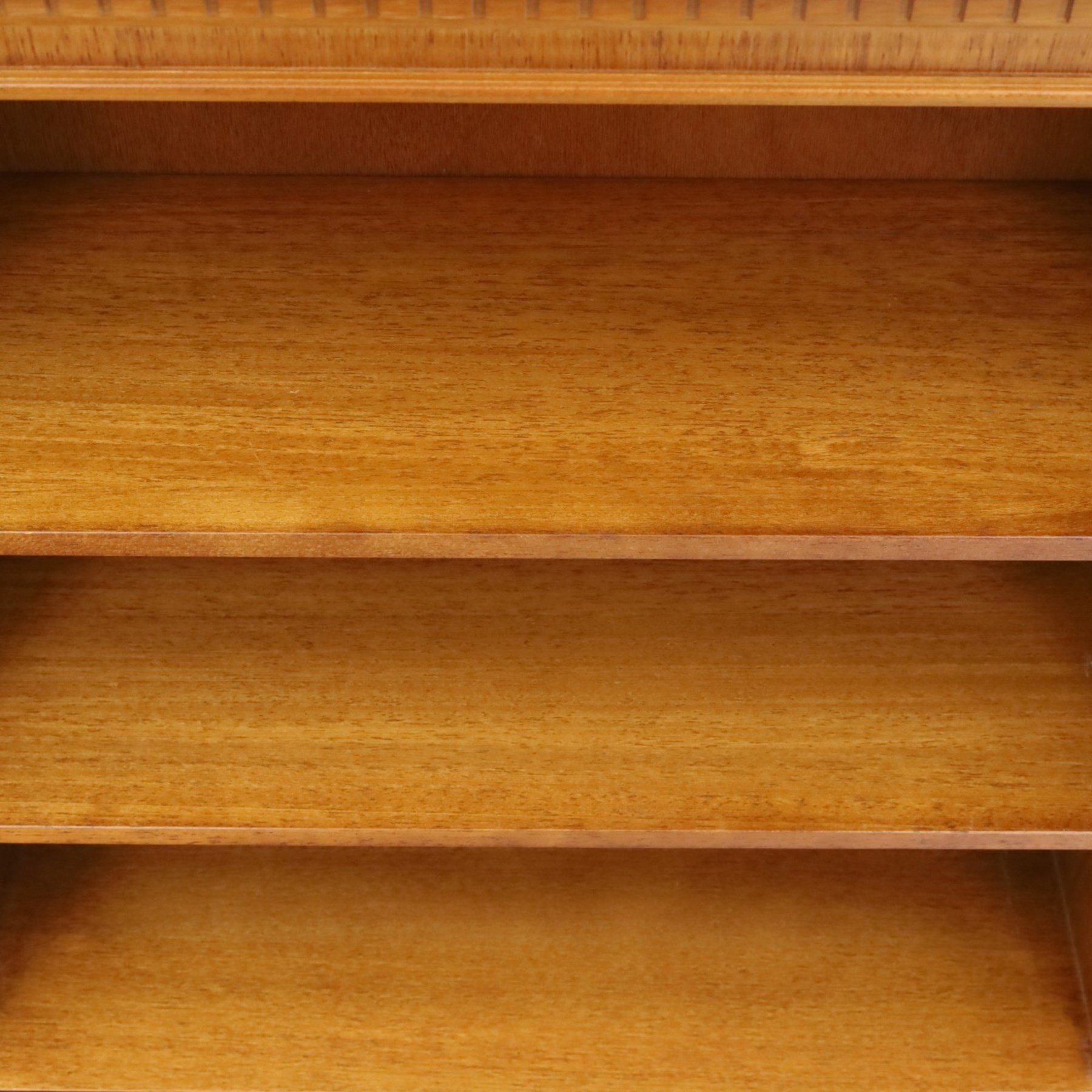 Contemporary mahogany and yew wood open bookcase, dentil cornice above two adjustable shelves, shaped apron and bracket feet 