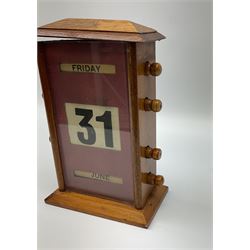An early 20th century oak perpetual desk calendar, with three glazed apertures for day, date and month, H20cm