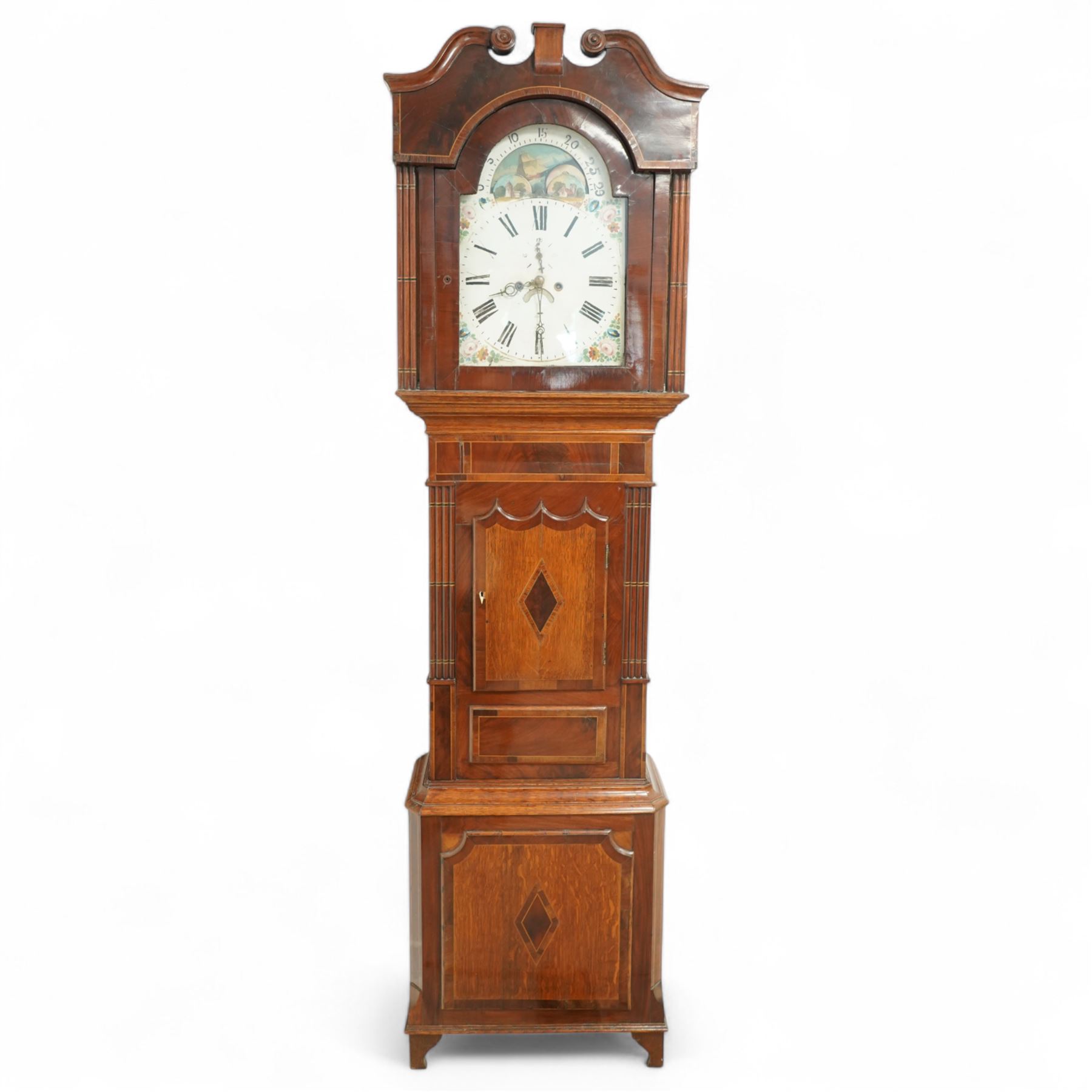 Mid 19th century- 8-day oak and mahogany longcase clock, with a carved swan necked pediment and crossbanding, break-arch hood door flanked by reeded pilasters, broad trunk with matching pilasters to the sides, short triple spire door with inlay and a and raised panel beneath, plinth with a conforming inlaid panel to the front, raised on backet feet, painted dial with floral spandrels and a rolling moon to the arch, broad Roman numerals, seconds dial, date aperture and stamped brass hands, dial pinned to a rack striking weight driven movement striking the hours on a bell. With weights and pendulum.