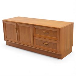 G Plan - 'Fresco' teak side unit, rectangular top above twin cupboard doors and two drawers, drawers fitted with cassette tape storage and a fall front drawer, raised on a plinth base
