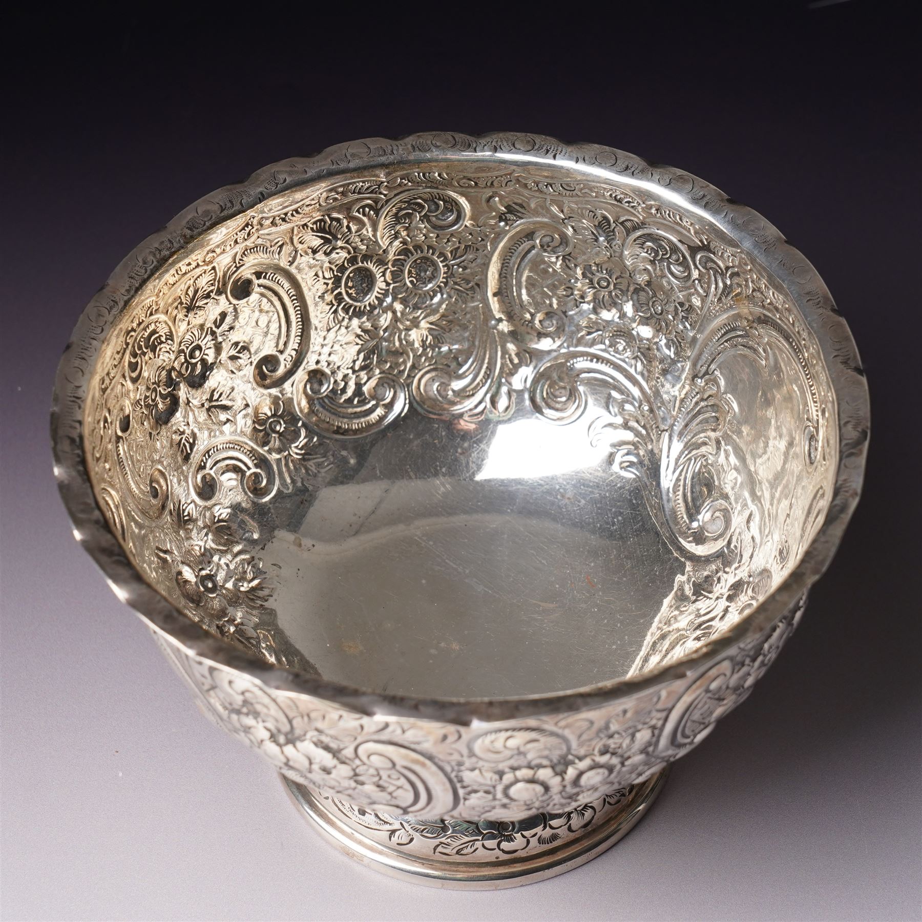 Late Victorian silver bowl embossed with flower heads and scrolls and with vacant cartouches on short pedestal foot D17cm London 1900 Maker Goldsmiths & Silversmiths Company