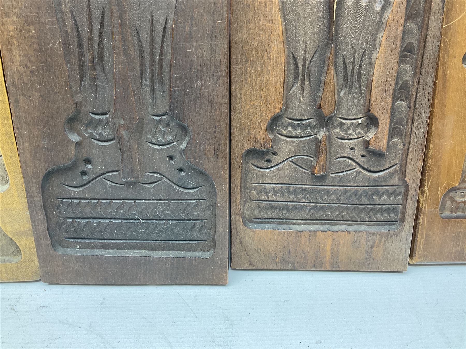 Six 20th century hardwood Dutch folk art Speculaasplank or biscuit moulds, typically carved with figures in traditional dress, largest H101cm
