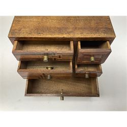 Early 20th century Japanese writing slope, the exterior cover with geometric parquetry, opening to reveal a lacquered fitted interior, H10cm L37cm D30cm, together with a small table top set of drawers with similar decoration, H13cm L15cm D7cm