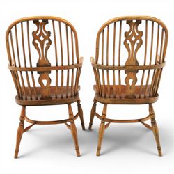 Pair of high back Windsor armchairs, fleur de lis back splat, dished seat, caroline stretcher