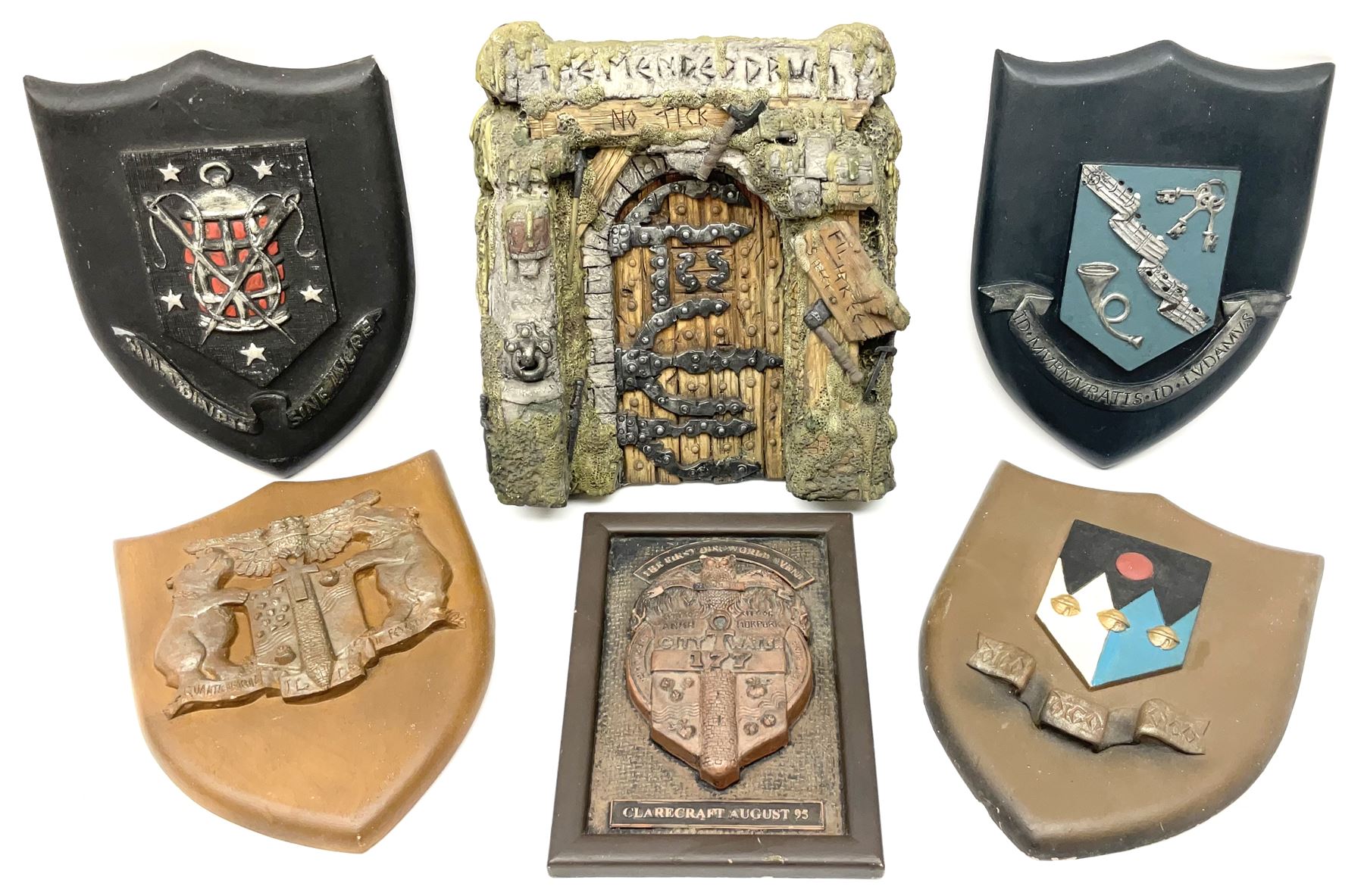 Terry Pratchett Discworld plaques, designed by Clarecraft, comprising 'the First Discworld Event Clarecraft August 95', the collectors guild joining shield, the fools guild DW99C, the seamstresses guild DW98C, the musicians guild DW00C together with 'Door of the mended drum' wall hanging DW17. 