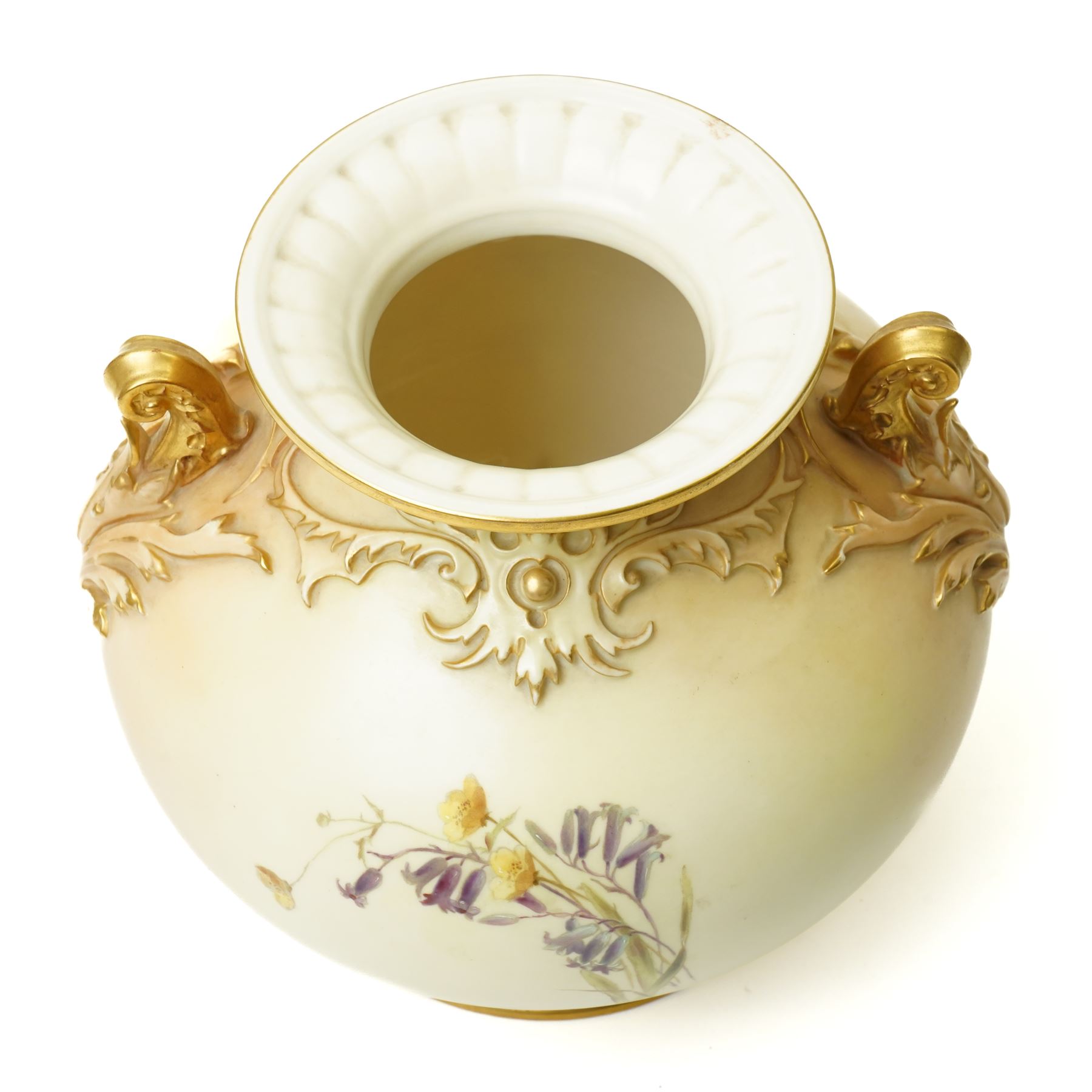 Late Victorian Royal Worcester vase of baluster design with gilt handles and painted with flowers on a blush ivory ground H22cm, date code for 1892