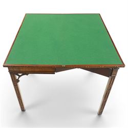 George III Chippendale design mahogany table, the rectangular hinged top with geometric carved edge, opening to reveal a baize-lined interior supported by twin concertina rear gateleg supports, over a banded frieze and pierced C-scroll spandrels, the inner chamfered square supports carved with geometric blind-fretwork detail