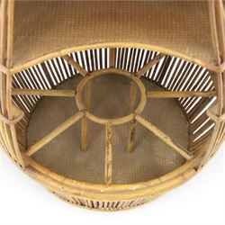 Italian mid-20th century barrel-shaped bar cart in rattan and bamboo, the circular top with rattan and bamboo handle, above a rattan shelf with bamboo bottle dividers below, raised on castors