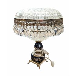 Ceramic table lamp, decorated with florals on a blue ground, with frosted glass shade with glass droplets, with two pin plug