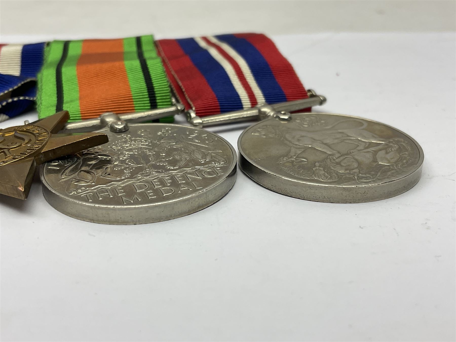 WWII group of five medals comprising 1939-45 War Medal, Defence Medal, 1939-45 Star, Africa Star and France and Germany Star on wearing bar; WWI British War Medal awarded to 142019 Pte. A. Thompson A.S.C.; and boxed King's Badge 'For Loyal Service'