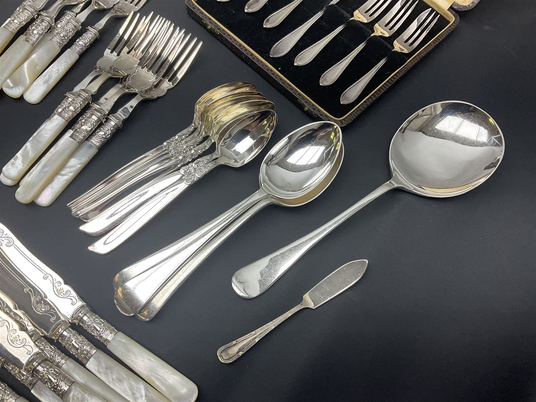 Mother of Pearl handled cutlery, with silver ferrules, comprising six fish knives and forks and six fruit knives and forks, the ferrules hallmarked Yates Brothers, Sheffield 1905, together with silver plated Edwardian three piece tea service and other flatware 