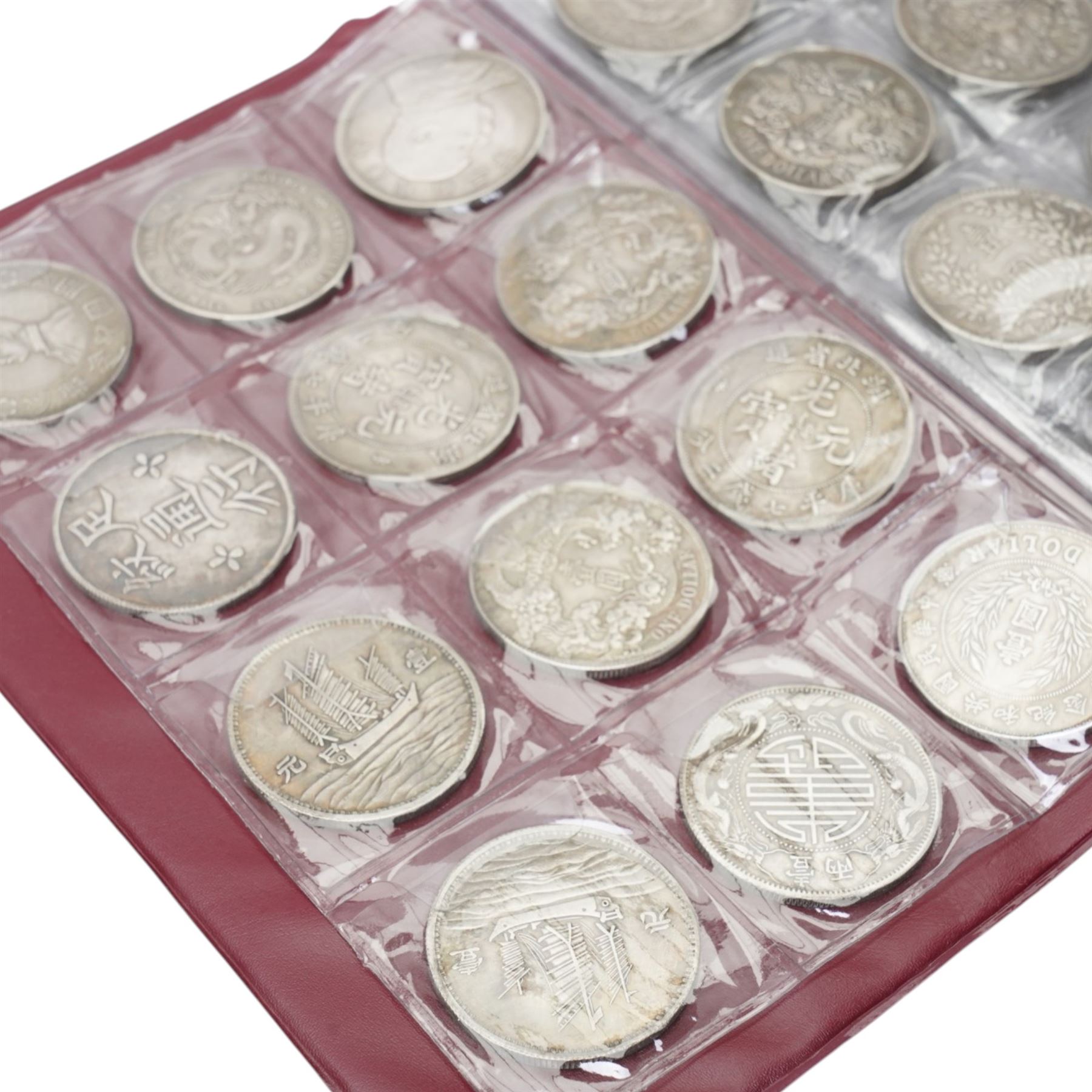 Folder containing various Chinese coins 