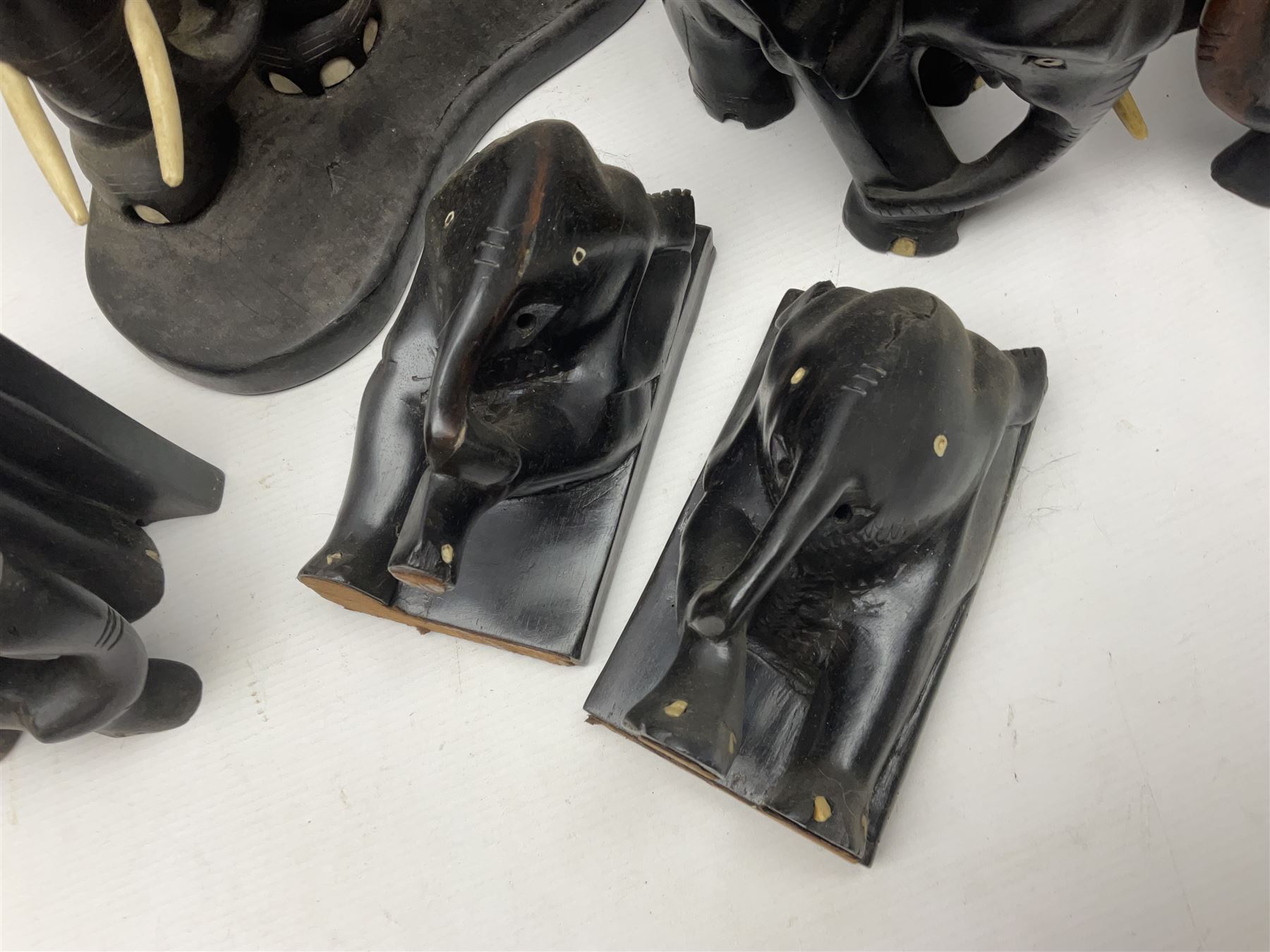 Three pairs of carved wooden elephant bookends, and a similar carved wooden elephant figure, tallest H24cm