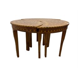 20th century hardwood and marquetry nest of three tables, the three shaped triangular tables fitting together as one circular coffee table, the tops inlaid with ebony and mother of pearl flower heads with parquetry borders, raised on tapered supports
