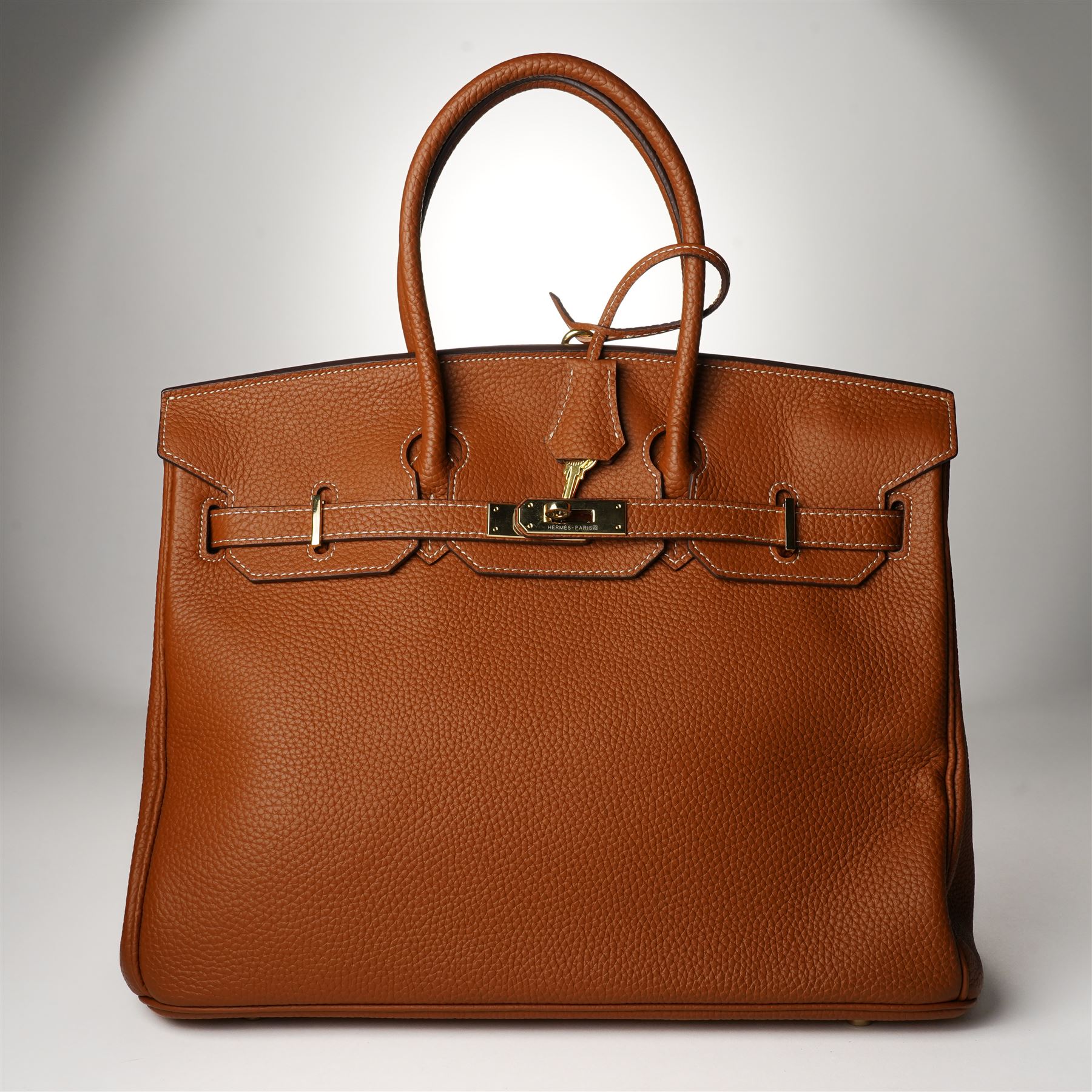 Hermès - gold hardware 'Birkin 35' handbag in gold Togo leather with white stitching, featuring gold-plated hardware, double rolled handles, front flap, belted turn-lock closure, and leather lining with one zip and one slip pocket, stamped 'Hermes Paris Made in France' in gold, with blind-stamp Q (2013) with craftsman’s code 70A to the underside of locking belt. Accompanied by: padlock, keys, clochette, Hermes dust bag, booklet, and ribbon. New unused condition.