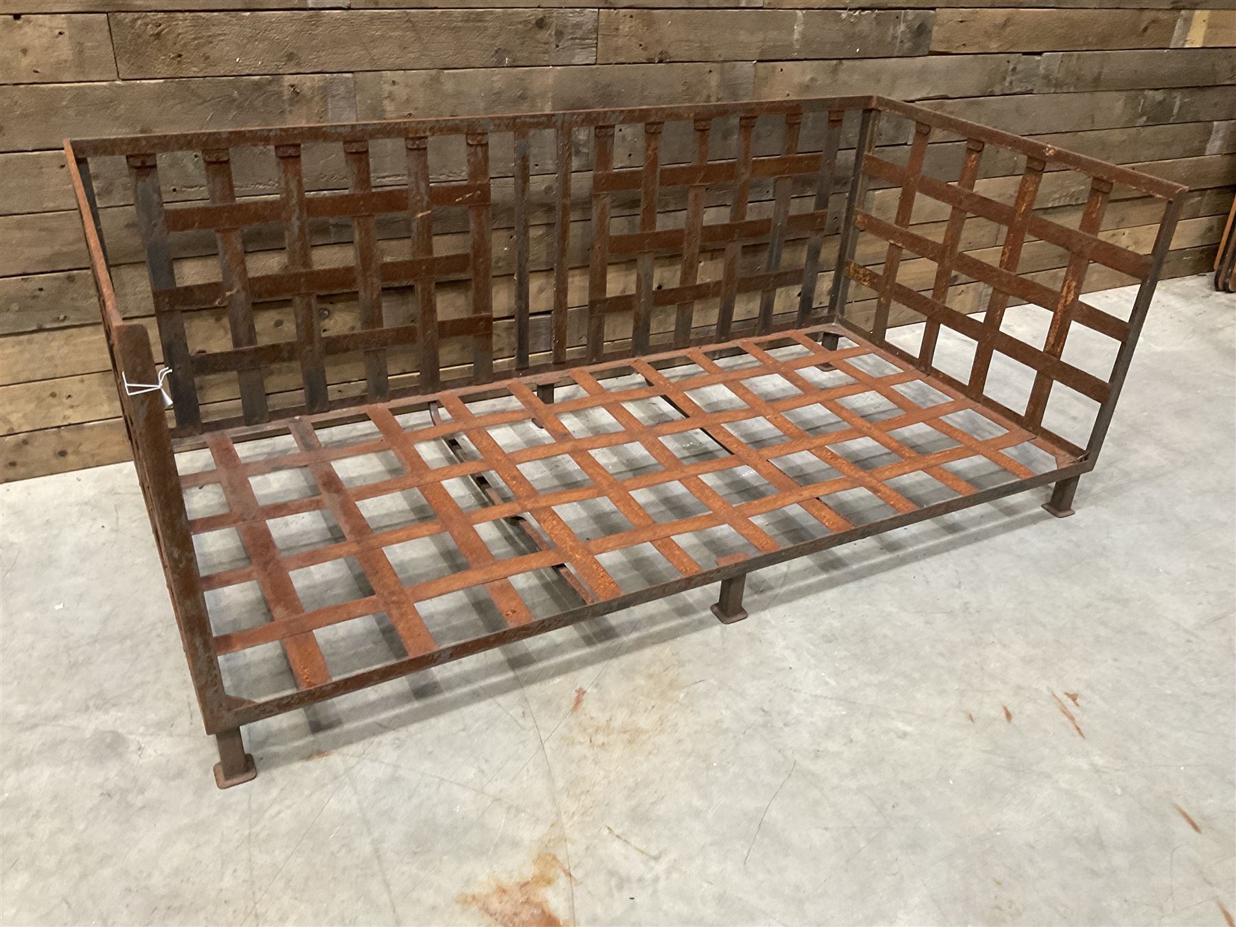 Wrought iron strapwork garden day bed, lattice back and sides