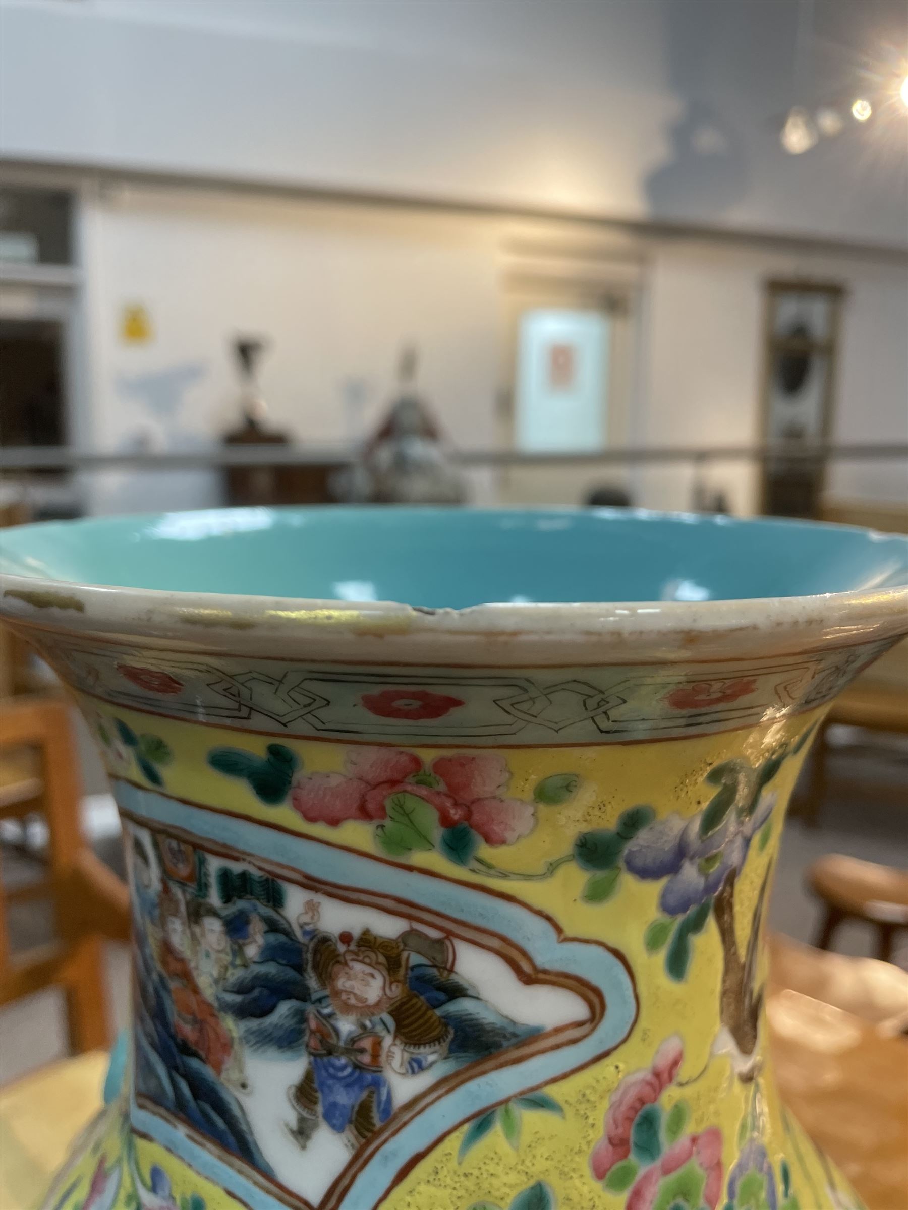 19th century Chinese famille rose yellow ground porcelain vase, of baluster form with twin applied mask ring handles, the body decorated with two shaped reserves mounted with dragon heads, depicting warriors at battle and at court, the neck with two smaller conforming figural reserves, upon a yellow ground decorated with exotic birds amidst scrolling blossom, H45.cm