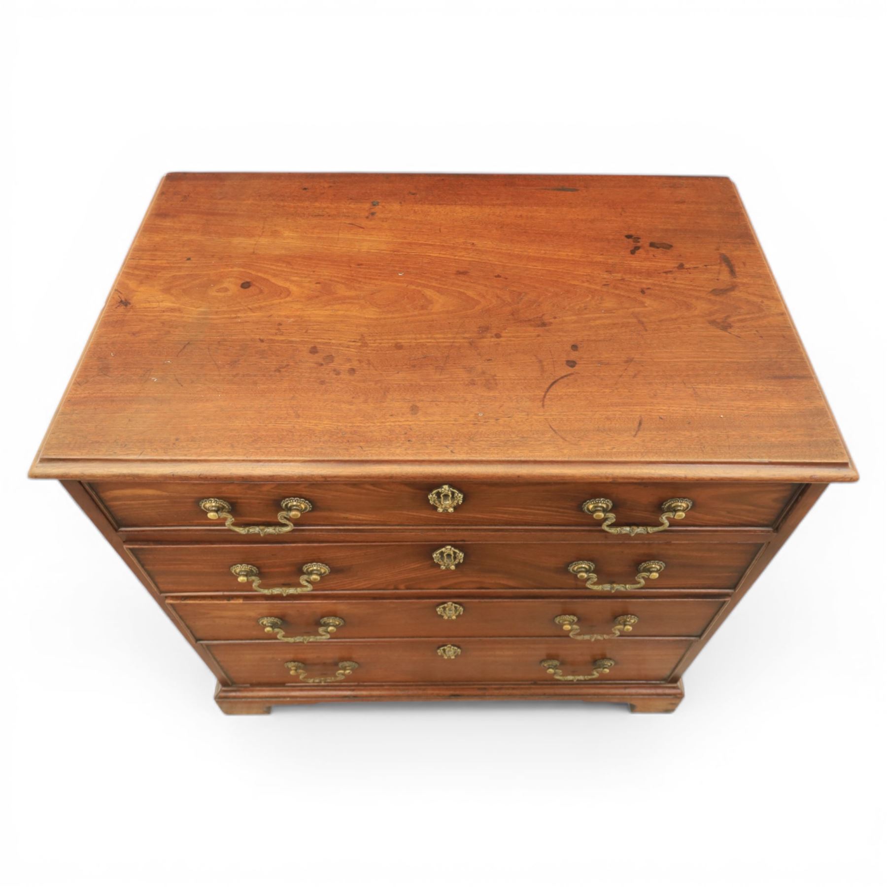 Georgian mahogany dwarf chest of drawers, the moulded rectangular top over four graduated drawers, fitted with brass drop handles, upon shaped bracket feet