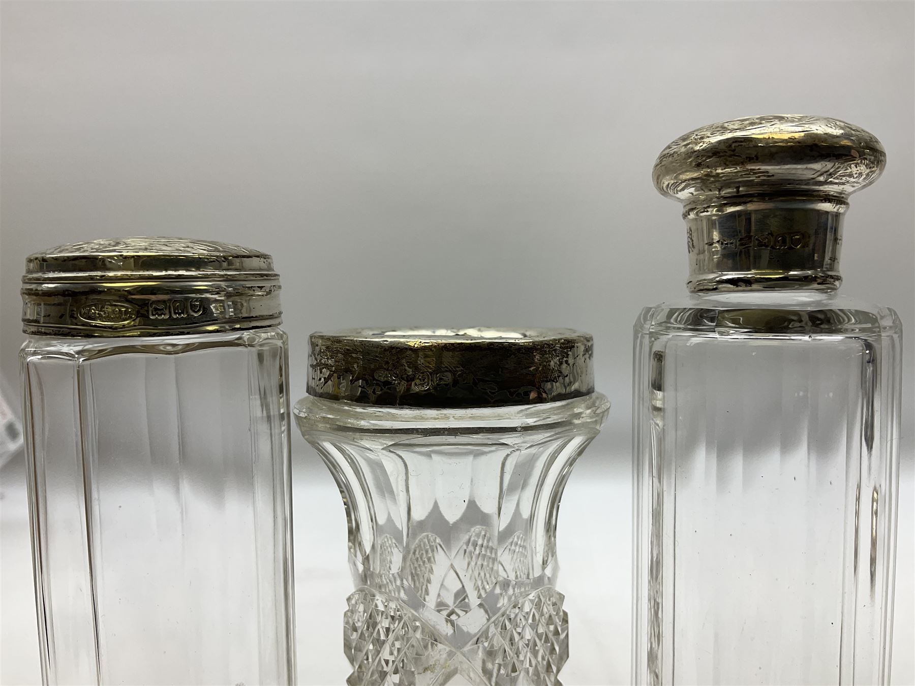 1920's silver stand, hallmarked Birmingham 1922, together with two tall faceted clear glass dressing table jars with hallmarked silver covers, and cut glass vase with hallmarked silver mounted collar, and small group of silver handled accessories, including files, picks, etc., approximate total silver weight 58.8 grams